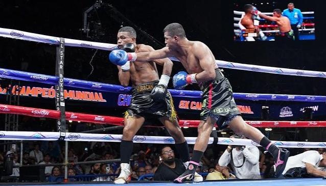 Rober Barrera contra las cuerdas soportando el ataque de 'Chocolatito' González.
