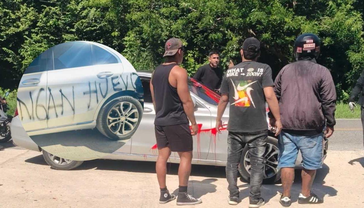 Paiva saliendo de su vehículo y a su alrededor los barristas.