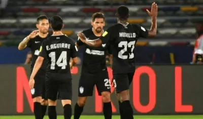 Jugadores del Pachuca celebran tras una anotación. 