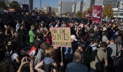 Un manifestante muestra un cartel que dice 'Por una Alemania colorida' (C) en una manifestación titulada '#indivisible - solidaridad en lugar de exclusión' en Berlín, Alemania.