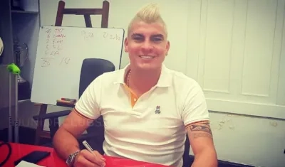 Michael Rangel firmando su contrato por tres años de Junior. 