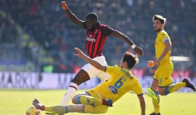 El centrocampista del AC Milán Tiemoue Bakayoko (i) y el defensa del Frosione Edoardo Goldaniga (c) pelean por el balón.