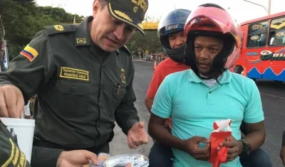El coronel Francisco Arias, Comandante Operativo de la Policía del Atlántico, entrega muñecos en miniatura para fin de año.