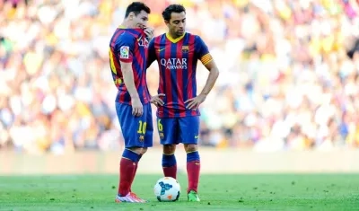 Lionel Messi y Xavi Hernández. 