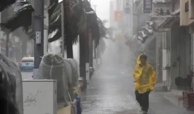 Un ciudadano japonés desafía los vientos del tifón Trami el sábado.