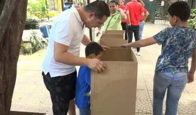 Padre de familia acompañando a su hijo a votar en el Zoo.