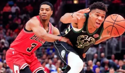 El alero griego Giannis Antetokounmpo (d) de Milwaukee Bucks en acción ante el escolta Shaquille Harrison (i) de Chicago Bulls.