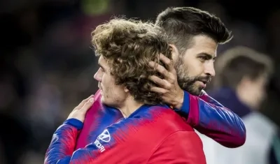 Antoine Griezmann se abraza con Gerard Piqué. 