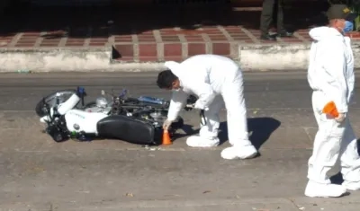 Momento en que la Policía revisa la motocicleta en la que iban los presuntos atracadores. 