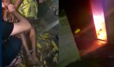 El hombre cuando era auxiliado por vecinos con la habitación incendiada.