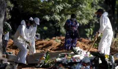 Empleados cargan el ataúd de una persona que murió por Covid-19 en el cementerio de Vila Formosa en Sao Paulo (Brasil).