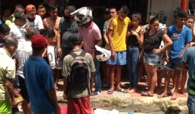 Las personas se aglomeraron alrededor del cuerpo del hombre que fue asesinado en el sitio. 