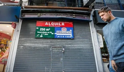 Un hombre pasa junto a un local cerrado, en Buenos Aires (Argentina).