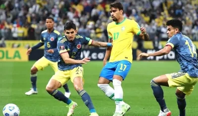 Daniel Muñoz y Luis Díaz controlando una llegada de Lucas Paquetá.