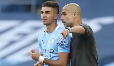 Ferran Torres y Pep Guardiola.