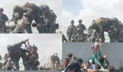 Un bebé es entregado a soldados por una valla en el aeropuerto de Kabul, en Afganistán.