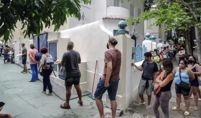 Decenas de personas hacen fila para tomarse una prueba de detección de coronavirus.