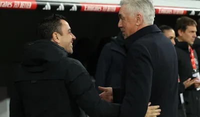 Carlo Ancelotti se saluda con Xavi Hernández, técnico del Barcelona.