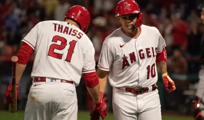 Gio Urshela se saluda con su compañero Matt Thaiss.