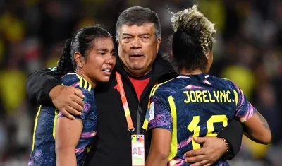 El técnico de Colombia, Nelson Abadía, consuela a sus jugadoras Daniela Arias y Jorelyn Carabalí. 