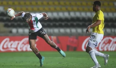 Junior Marabel, de Millonarios, cabecea hacia el arco de Millonarios, ante la mirada de Danovis Banguero.