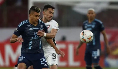 Víctor Cantillo disputa la pelota con Lisandro Alzugaray. 