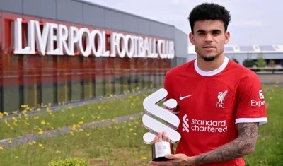 Luis Díaz con el trofeo entregado por Standard Chartered, patrocinador del Liverpool.