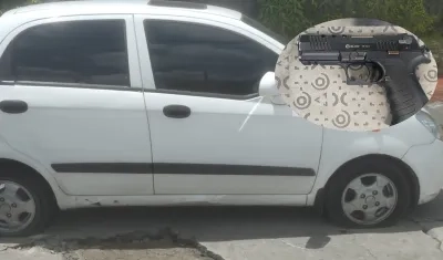 Vehículo y arma de fuego incautada. 