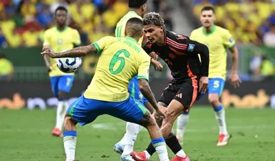 Richard Ríos en disputa del balón con Guilherme Arana.