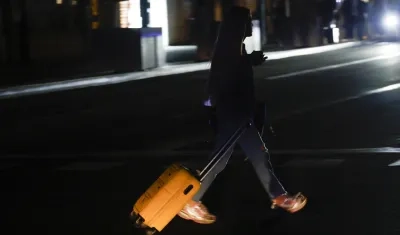 Una joven transita por una calle en Barcelona durante el apagón.