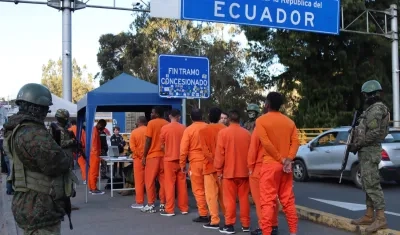 Integrantes de las Fuerzas Armadas de Ecuador custodian a presos colombianos durante su proceso de deportación.