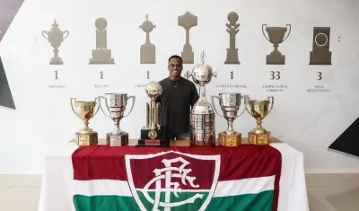 Jhon Arias junto a los trofeos conquistados por Fluminense. 