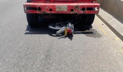 La motocicleta quedó debajo de la volqueta. 