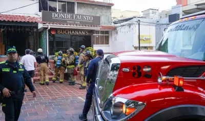 Los bomberos atendiendo la emergencia en la licorería. 