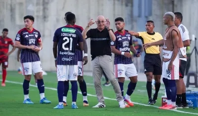 El técnico del Junior, Alfredo Arias, entrega indicaciones a sus jugadores.