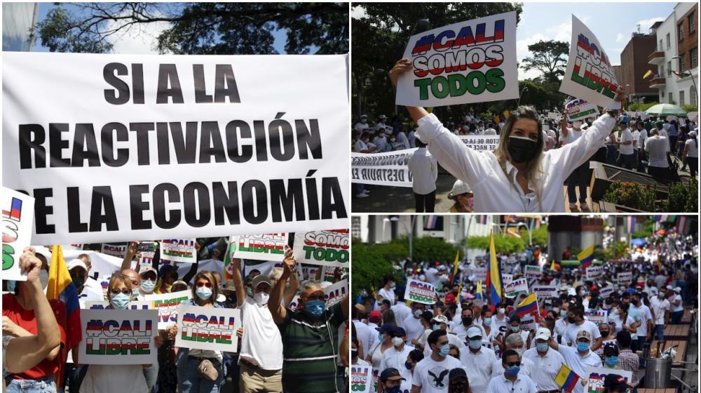 Manifestantes sostienen pancartas durante la "Marcha del Silencio", pidiendo que cesen los bloqueos y hechos de violencia tras 28 días de Paro Nacional, hoy, en Cali.
