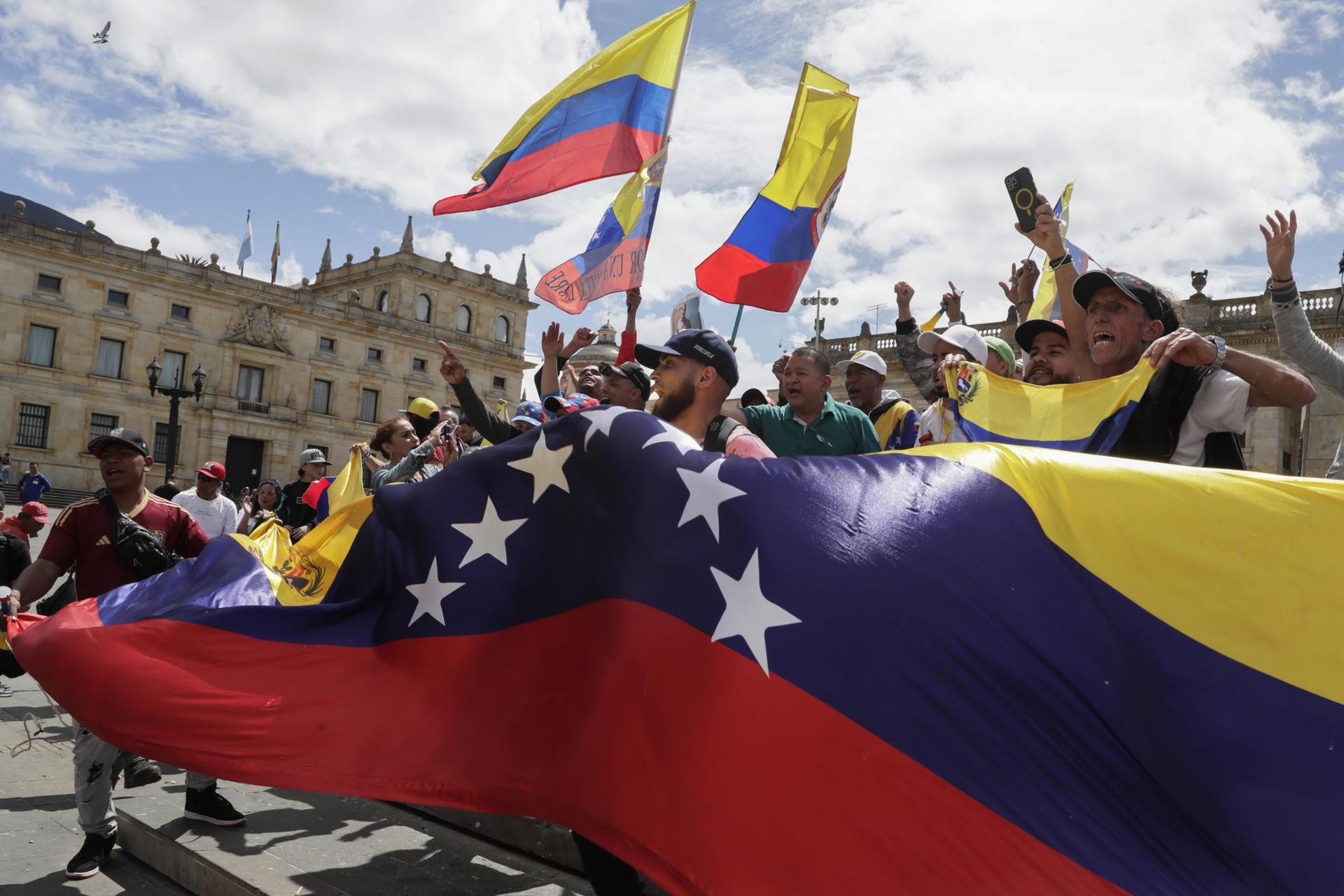 Ciudadanos venezolanos celebran durante una manifestación este sábado, en la Plaza de Bolívar en Bogotá